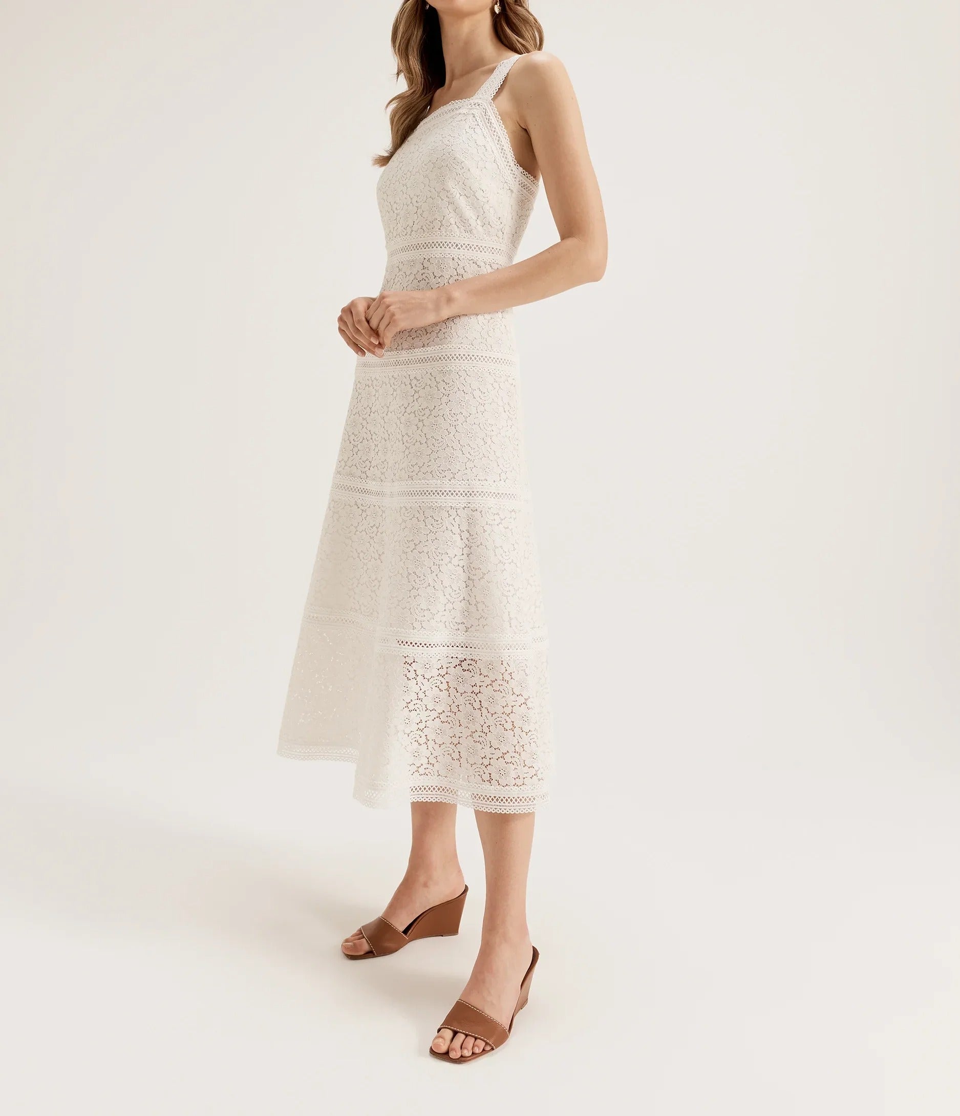 Cream sleeveless lace midi dress with fitted silhouette