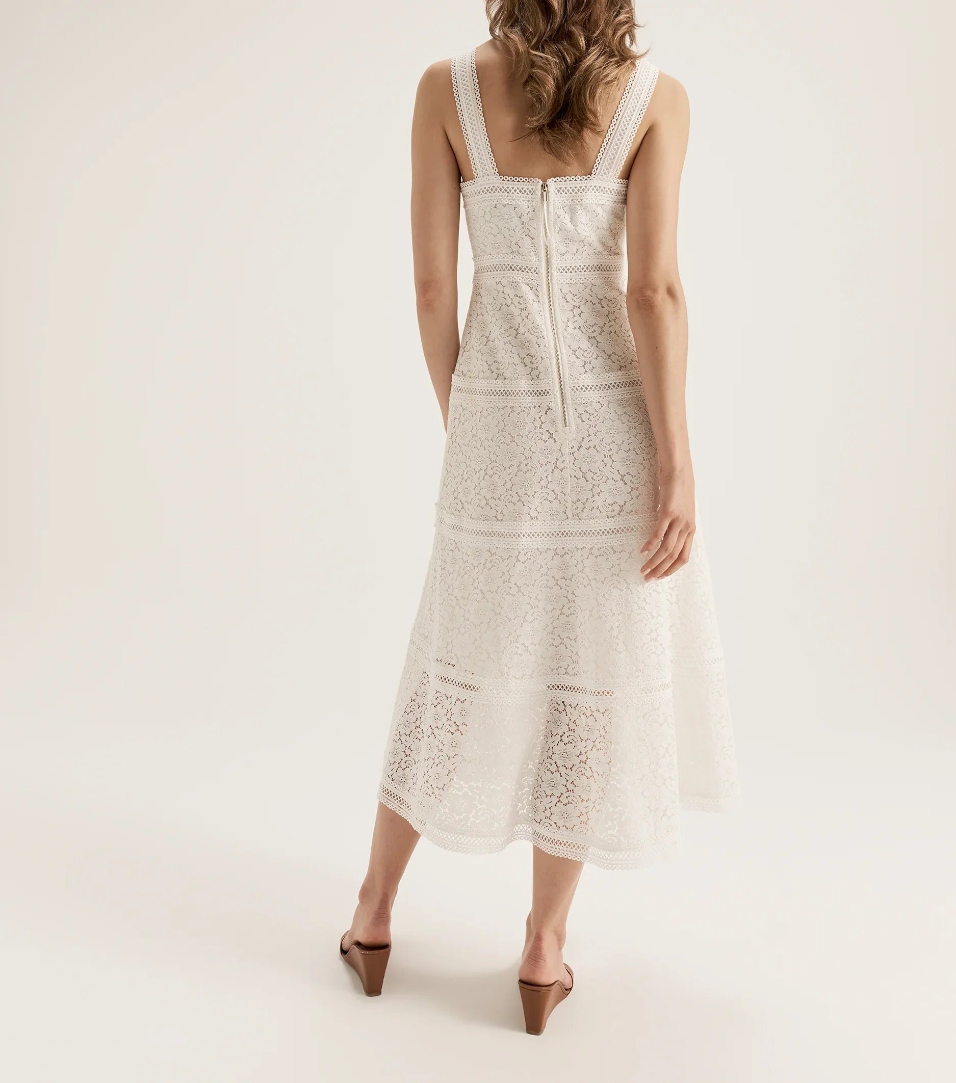 Cream sleeveless lace midi dress with fitted silhouette